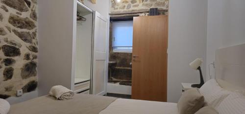 a bedroom with a bed and a window with a television at Casa do Rio - AL in Valença