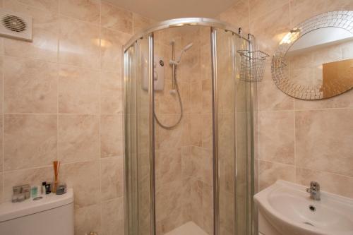 a bathroom with a shower and a sink at Chalet 106 in Deal