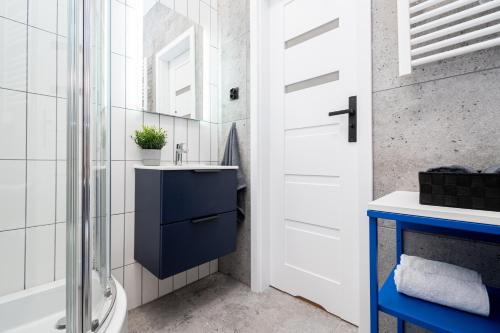 a bathroom with a sink and a toilet and a shower at Apartament Indygo16 in Kalisz