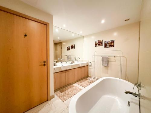 a large bathroom with a tub and a sink at The Seaside Charm Al Zeina505C1 in Abu Dhabi