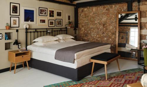 a bedroom with a large bed and a brick wall at Not Boutique Hotel in Athens