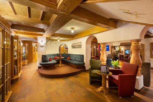 a lobby with couches and chairs in a building at IFA Alpenhof Wildental Hotel Kleinwalsertal Adults only in Mittelberg