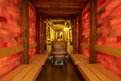 a room with benches and a brick wall at IFA Alpenhof Wildental Hotel Kleinwalsertal Adults only in Mittelberg