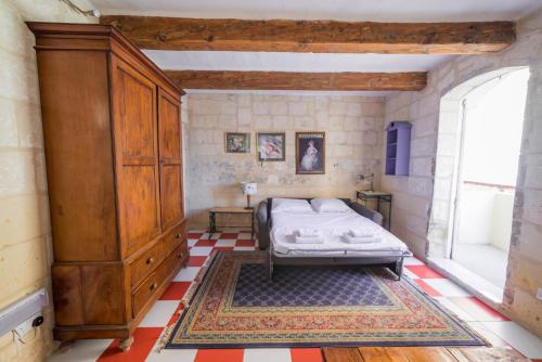 a bedroom with a bed and a large wooden cabinet at Vallettastay City break apartments in Valletta