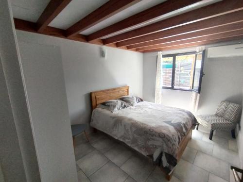 a bedroom with a bed and a window at Chez Fred Saint André in Saint-André