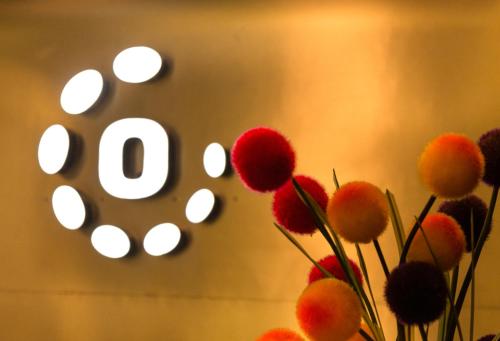 a bunch of red flowers in front of a clock at Octave Hotel & Spa - Sarjapur Road in Bengaluru
