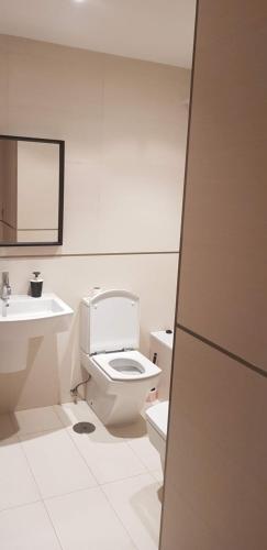 a white bathroom with a toilet and a sink at Centro Viveiro in Viveiro