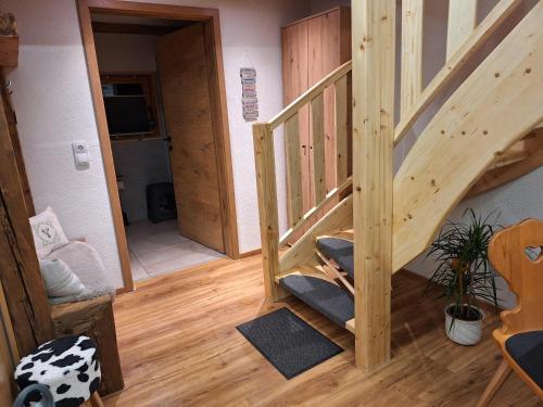 a room with a wooden staircase in a house at Leitnerbauer's Troadkasten in Donnersbach