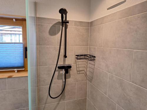 a shower with a shower head in a bathroom at Leitnerbauer's Troadkasten in Donnersbach
