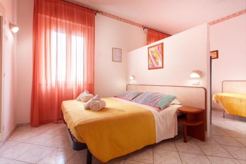 a bedroom with a bed with two stuffed animals on it at Hotel Atlantic in Gatteo a Mare