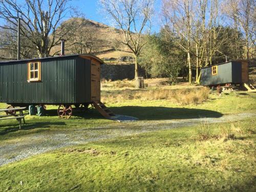 a train car sitting on the side of a road at Nab Shepherd's Hut in Rydal