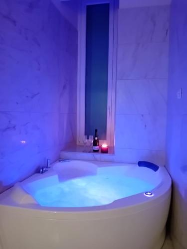 a bathroom with a tub with a bottle of wine in it at Bari Downtown Luxury Apartment in Bari