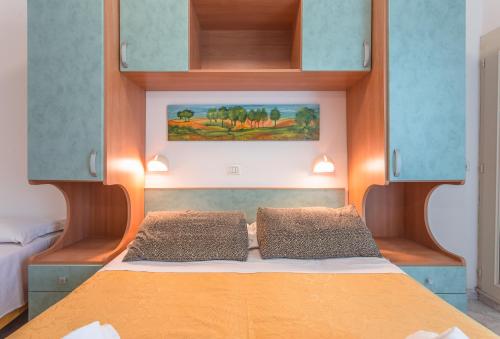 a bedroom with a bed with two pillows at Hotel Atlantic in Gatteo a Mare