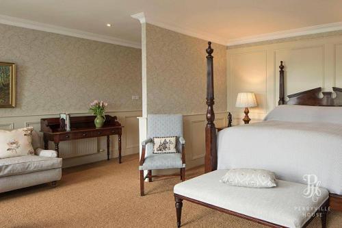 a bedroom with a bed and a desk and a chair at Perryville House in Kinsale
