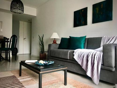 a living room with a couch and a table at Topacio Tower Apartamento Nara I in Buenos Aires