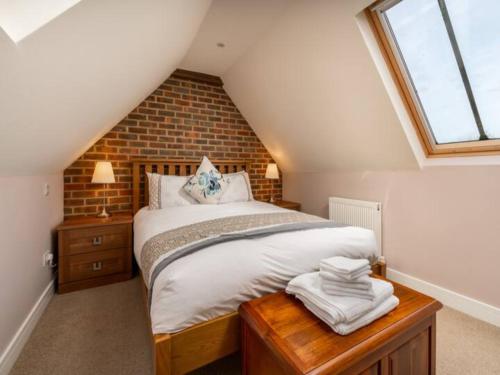 a bedroom with a large bed in a attic at Pass the Keys Tranquil Chilterns Farm Hideaway in Little Missenden