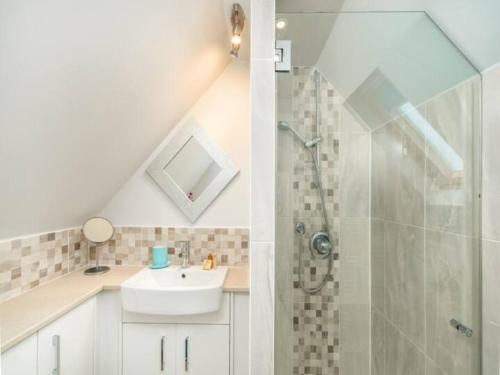 a white bathroom with a sink and a shower at Pass the Keys Tranquil Chilterns Farm Hideaway in Little Missenden