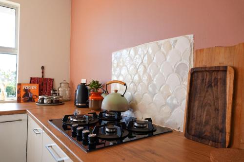 a tea kettle sitting on top of a stove in a kitchen at Soutelande Country Stay - Close to 1#Beach in PE in Port Elizabeth