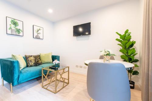 a living room with a blue couch and a table at Sky Stars Essential Reserve in Auckland