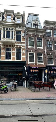 a group of buildings on a city street at Amsterdam Rembrandt Square city center Hotel in Amsterdam