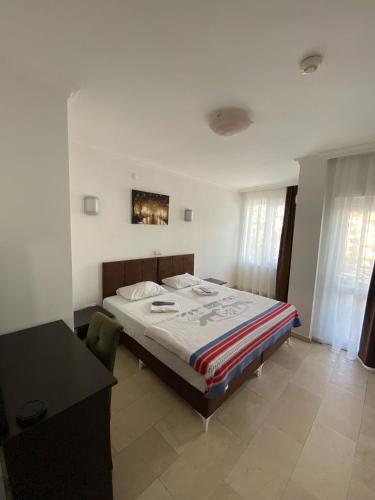 a bedroom with a bed and a desk in it at Alanya Central Apartments in Alanya
