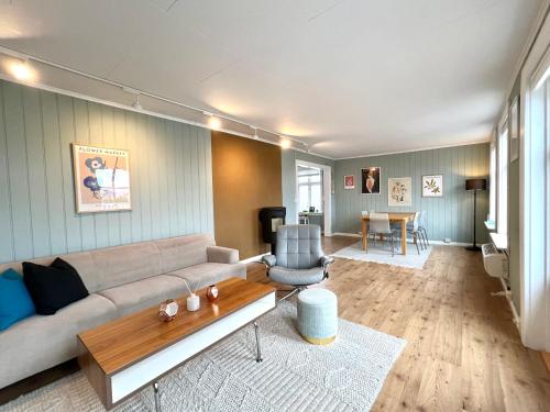 a living room with a couch and a table at Sentrum - Koselig hus med parkering in Arendal