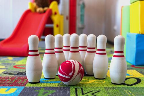a group of bowling pins and a ball on a table at Nykščio Namai & SPA in Anykščiai