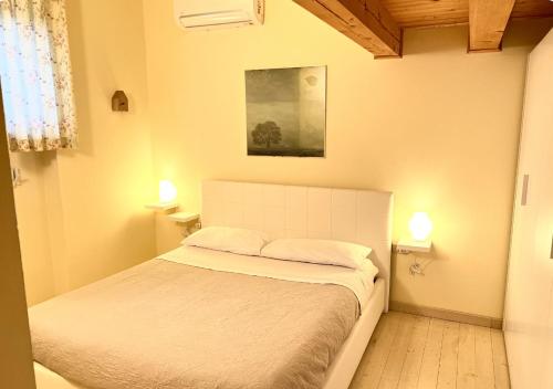 Ένα ή περισσότερα κρεβάτια σε δωμάτιο στο Villetta a 5 minuti dal mare di Fano