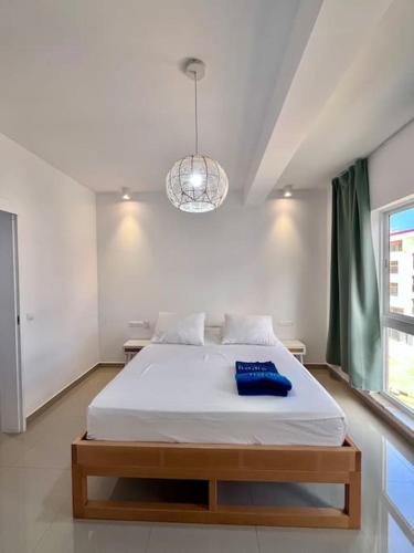 a bedroom with a large white bed in a room at Blissapartments T2 - Simone (nearby the beach) in Mindelo