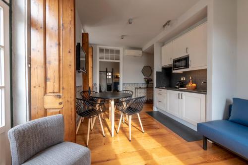 a kitchen and dining room with a table and chairs at Living Lisboa Baixa Apartments in Lisbon