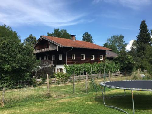 a house with a ping pong table in front of it at Ferien Haus am Feldgarten für 2 bis 9 Personen in Raubling