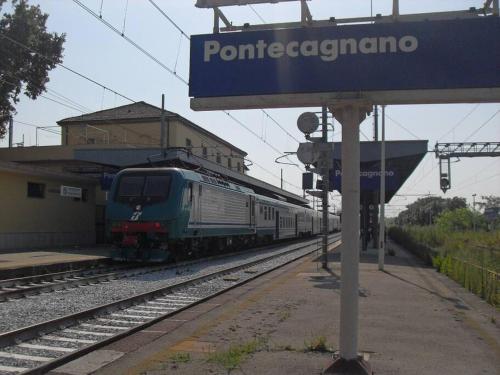 a train is pulling into a train station at Appartamento il Borgo di Baroncino in Faiano