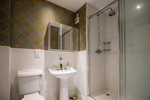 a bathroom with a toilet and a sink and a shower at Spacious, 3 Bed House for 6 in Central Chester in Chester