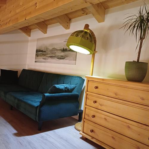 a living room with a couch and a lamp and a dresser at Bei Hillers in Obing