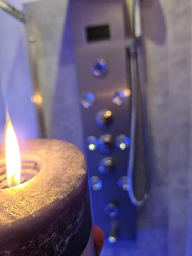 a person holding a candle in front of a shower at B&B Villa Maracujà in Ionadi