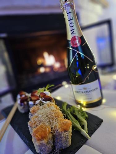 a plate of food and a bottle of wine at B&B Villa Maracujà in Ionadi