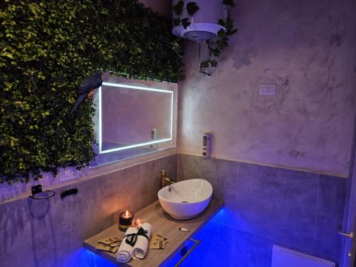 a bathroom with a bowl sink and a window at B&B Villa Maracujà in Ionadi