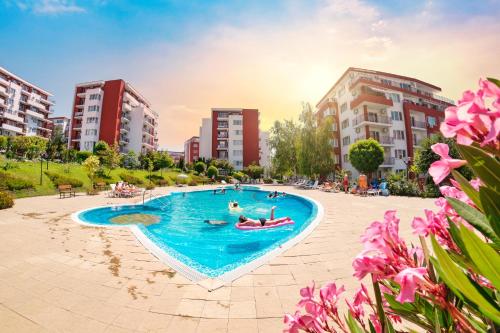 a group of people in a swimming pool in a city at Marina View Fort Beach in Sveti Vlas