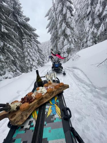 a tray of food sitting on top of a snow covered slope at The Post Stana de Vale in Stana de Vale
