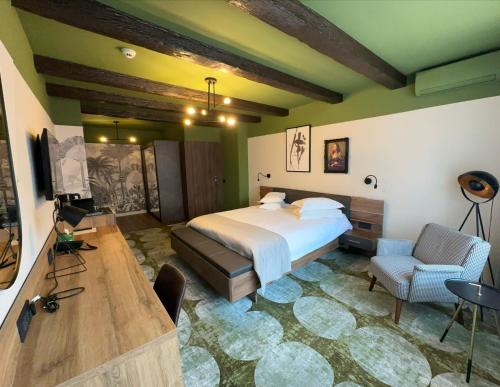 a bedroom with a bed and a desk and a television at Bucharest Comfort Suites Hotel in Bucharest