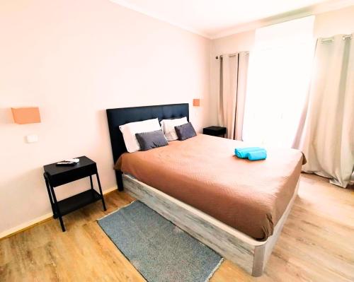 Un dormitorio con una cama con un objeto azul. en Appartement Praia da Rocha, en Portimão