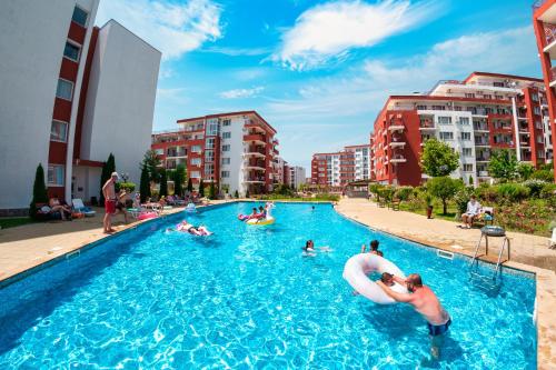 a group of people in a swimming pool in a city at Marina View Fort Beach in Sveti Vlas