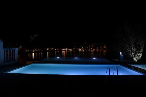 a swimming pool at night with a view of the city at Platys Gialos Hotel Sifnos in Platis Yialos Sifnos