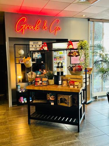 a store with a sign that reads grand and go at Best Western Plus Paris Orly Airport in Rungis