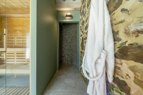 a walk in shower with a towel hanging on a wall at La Cotogna in Magione