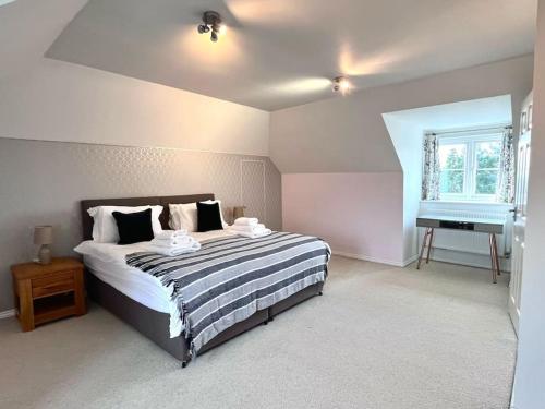 a bedroom with a large bed and a piano at Bright flat Chichester in Lavant