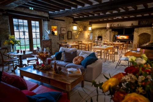 a living room with a couch and a table at Domaine de la Pommeraye & Spa in La Pommeraye