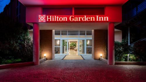 a building with a sign that reads hilinson garden inn at Hilton Garden Inn Bologna North in Bologna