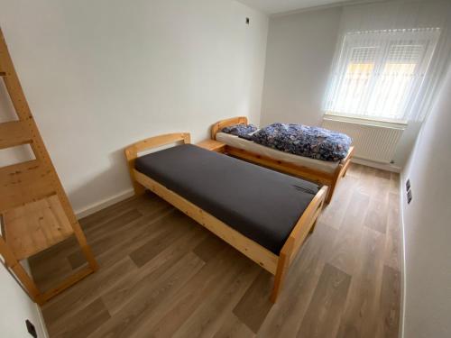 a small room with two beds and a ladder at Comfort Apartment Heilbronn in Heilbronn