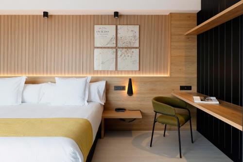 a hotel room with a bed and a desk at Nuvō Hotel Boutique in Oviedo